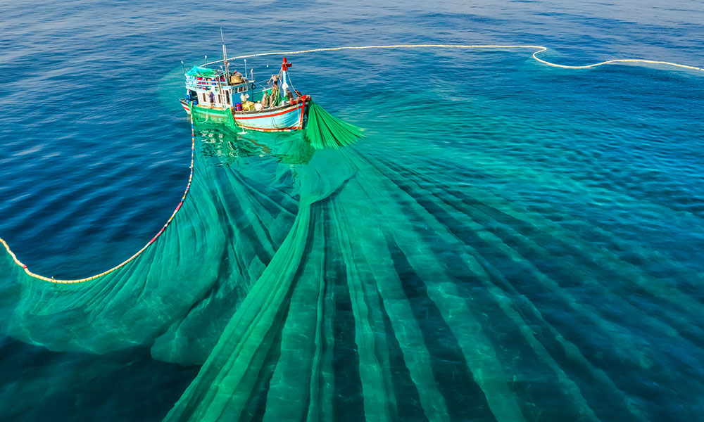 fishing boat at sea with a large net